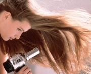 Woman drying her hair --- Image by © Peter Pfander/zefa/Corbis